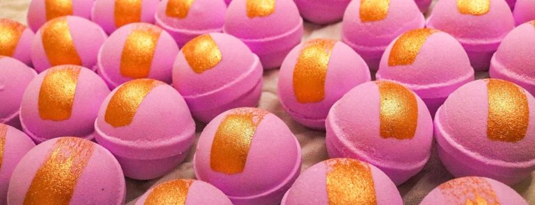 Lots of pink bath-bombs with a gold strip down the middle.