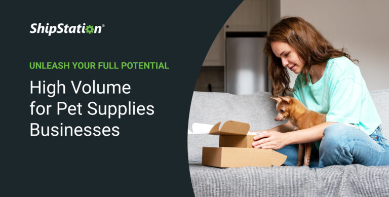 A woman sits with her dog on a couch with shipping boxes.